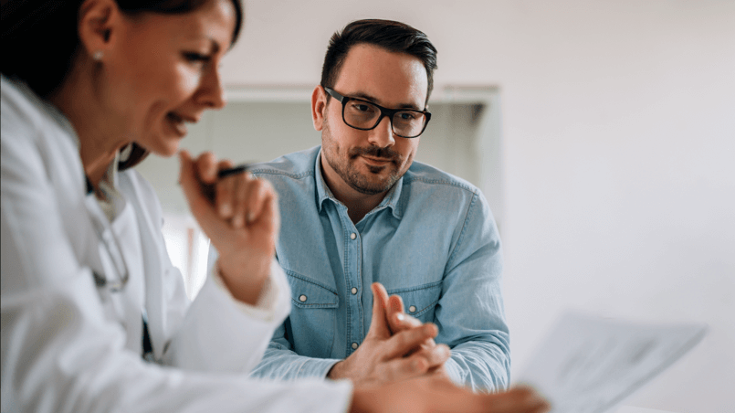 male patient consulting with female physician